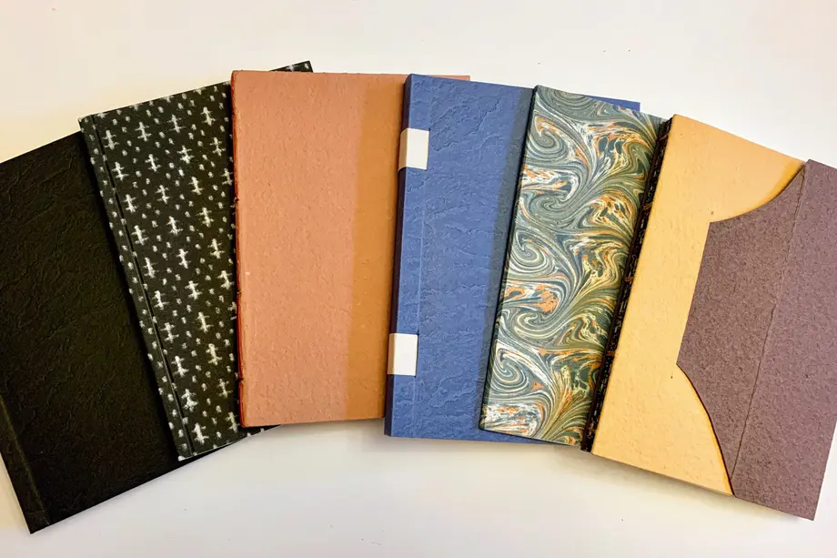 Six books spread in an arc