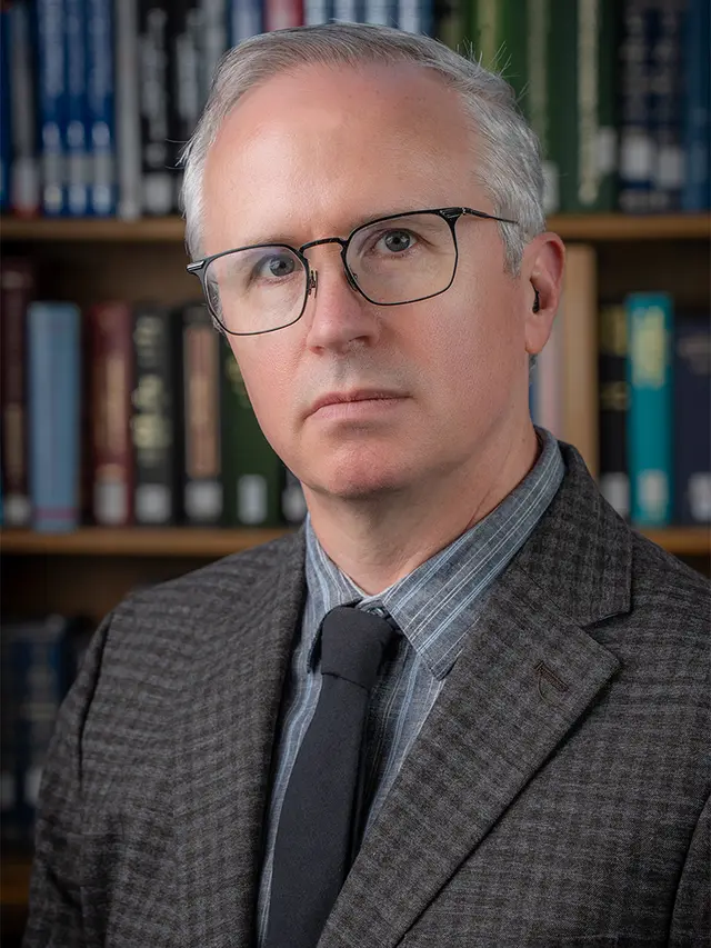 Photograph of Neil Robinson, a white man with short gray hair and glasses.
