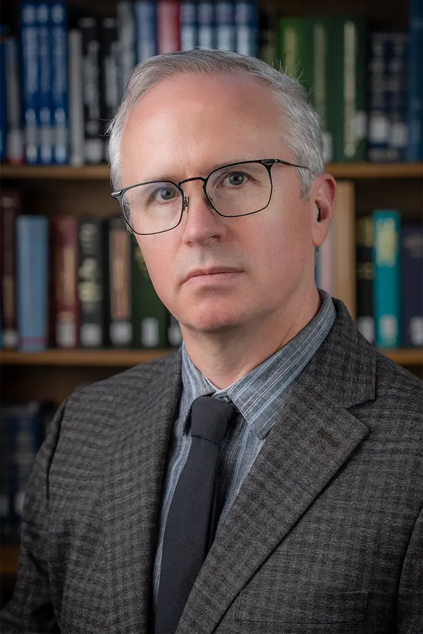 Photograph of Neil Robinson, a white man with short gray hair and glasses.