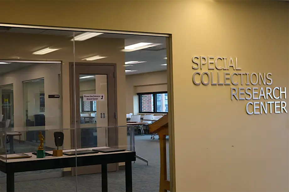Special Collections Research Center sign, with a window next to it looking into the space.