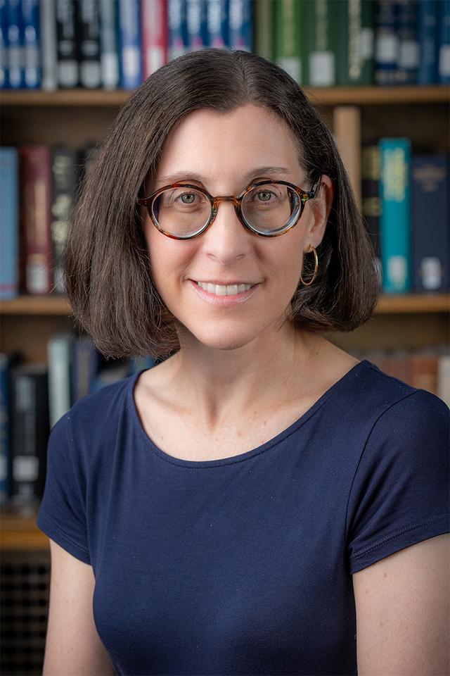 Photo of Kristen Castellana, a white woman with dark brown hair and glasses.