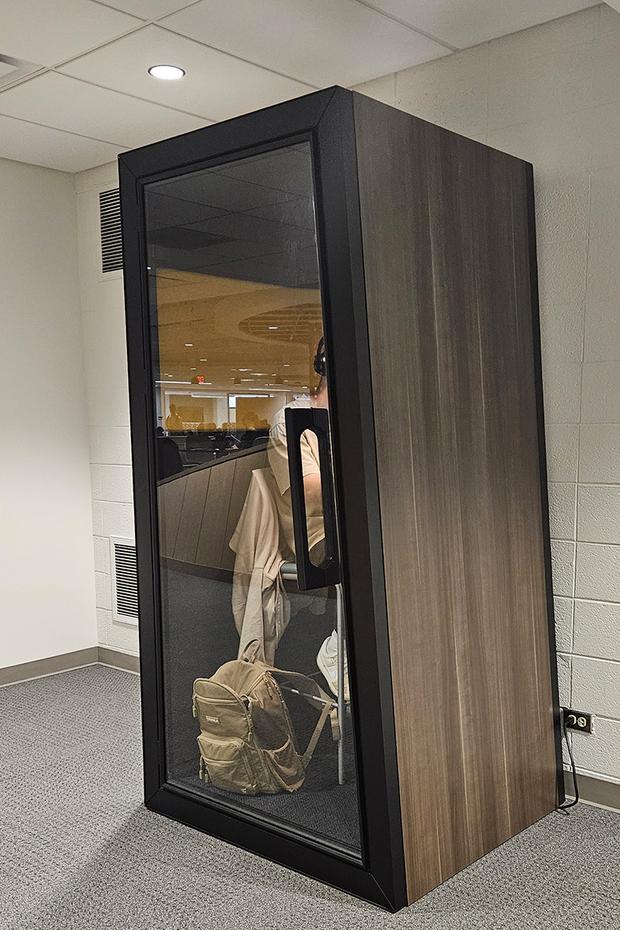 Student working inside an individual soundproof booth.