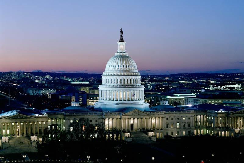 Aerial photograph of the United States Capitol Building at dusk.