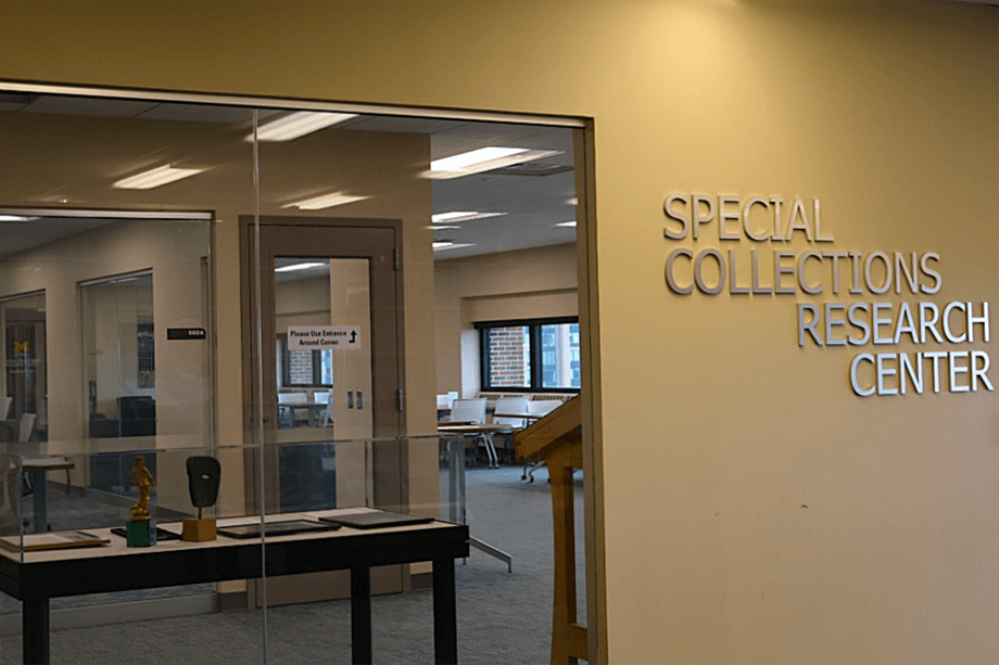 Special Collections Research Center sign, with a window next to it looking into the space.