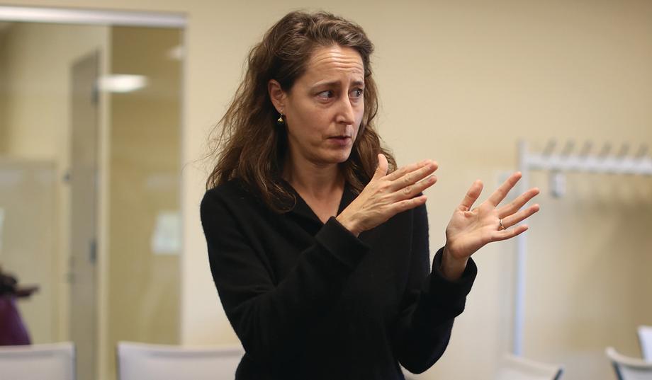 Woman gesturing with both hands.